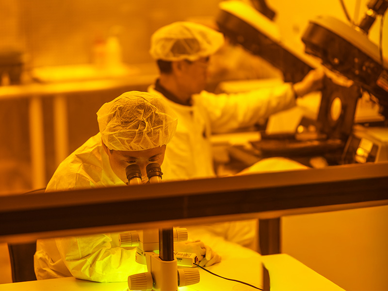 Dr. Weili Zhang and Dr. John Hu conduct research in the Clean Room lab. Dr. Weili Zhang and Dr. John Hu conduct research in the Clean Room lab.