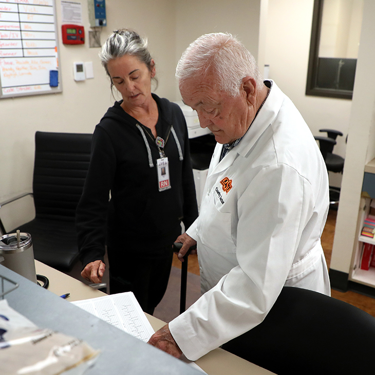 Dr. James Graham, right, looks over a patient's results with Registered Nurse Nikki Siler at Rural Wellness Fairfax Hospital in Fairfax, Oklahoma