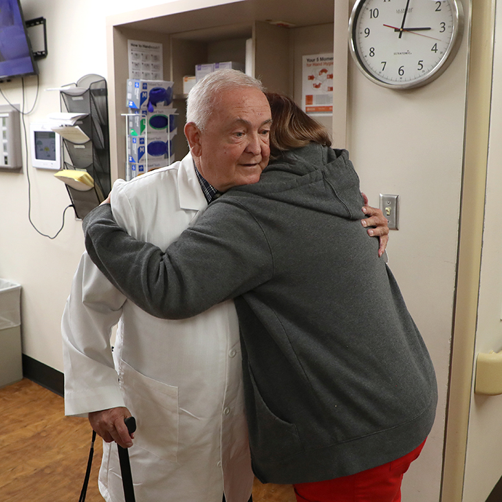OSU College of Osteopathic Medicine alumnus Dr. James Graham hugs nurse Allie Graves