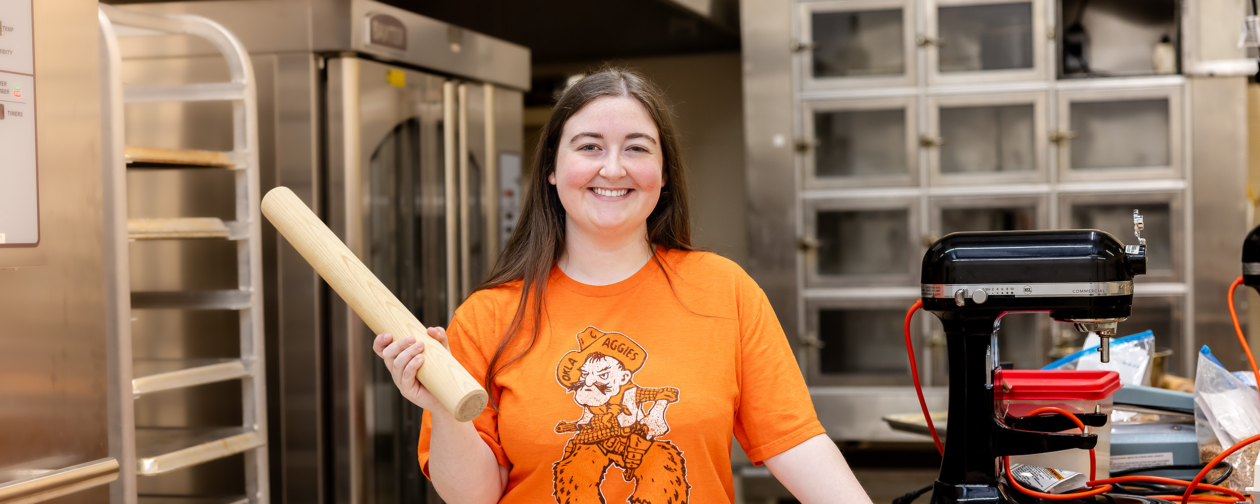  Emily Ward in kitchen holding wooden rolling pin