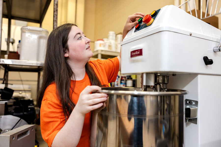 Emily Ward starts industrial-sized mixer in OSU kitchen