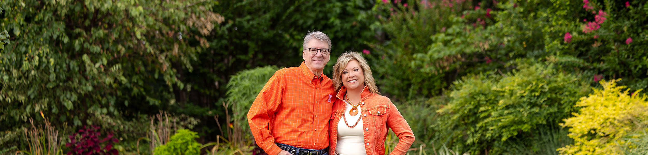 President Hess and First Cowgirl standing in front of a beautiful garden