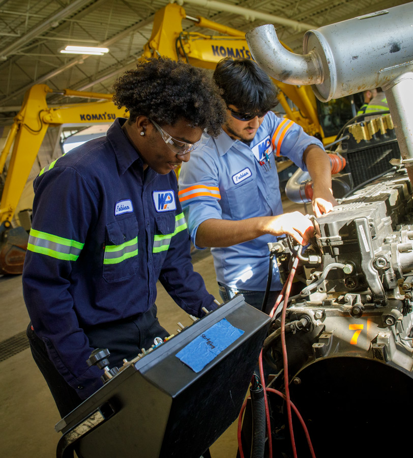 Students getting specific workforce training on heavy equipment in lab