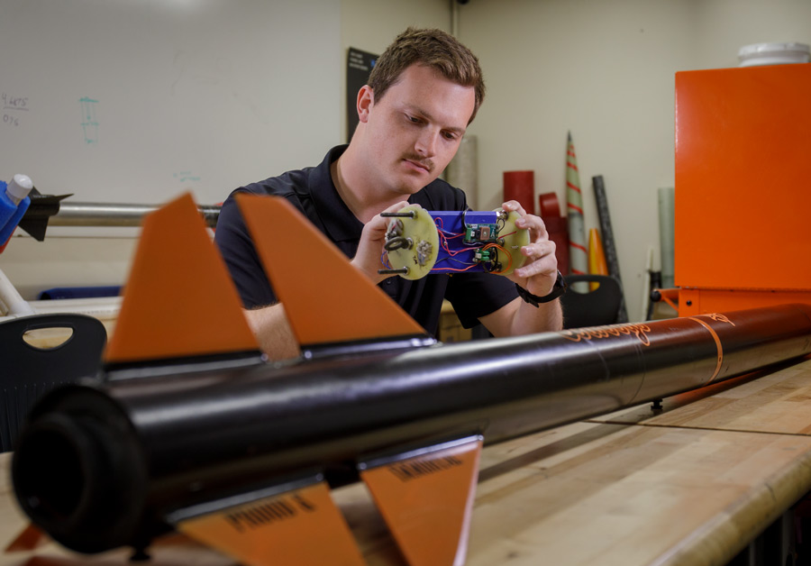 Student working on machine at desk