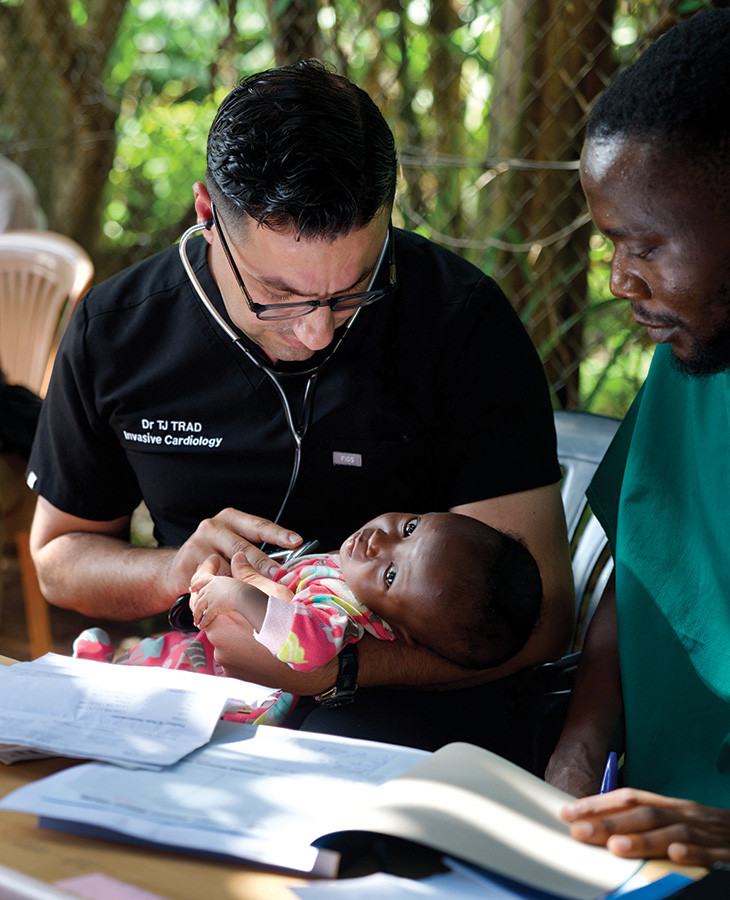 Dr. Trad listens to heart of girl in Zirobwe, Uganda