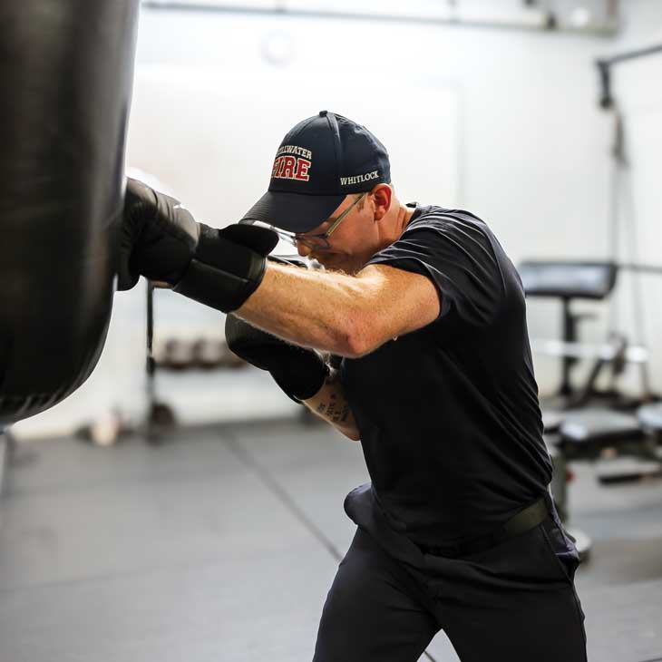 a firefighter performs a boxing workout a firefighter performs a boxing workout
